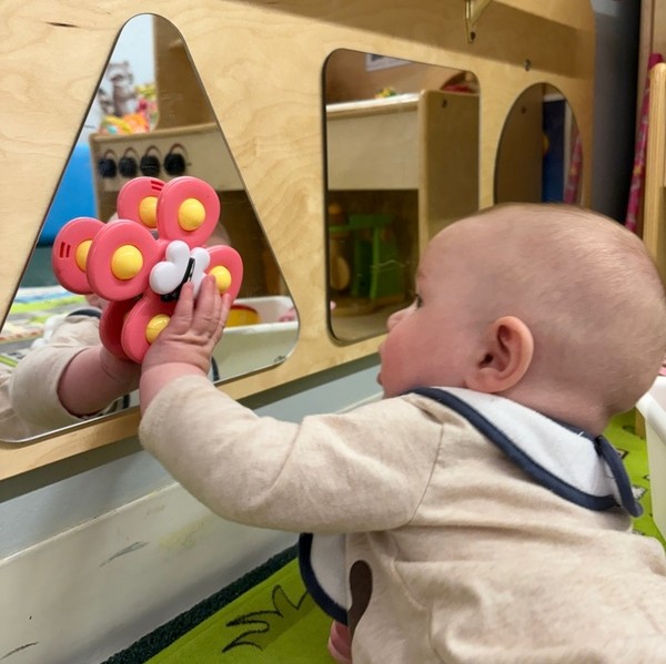 Children engaged in dramatic play at classroom table