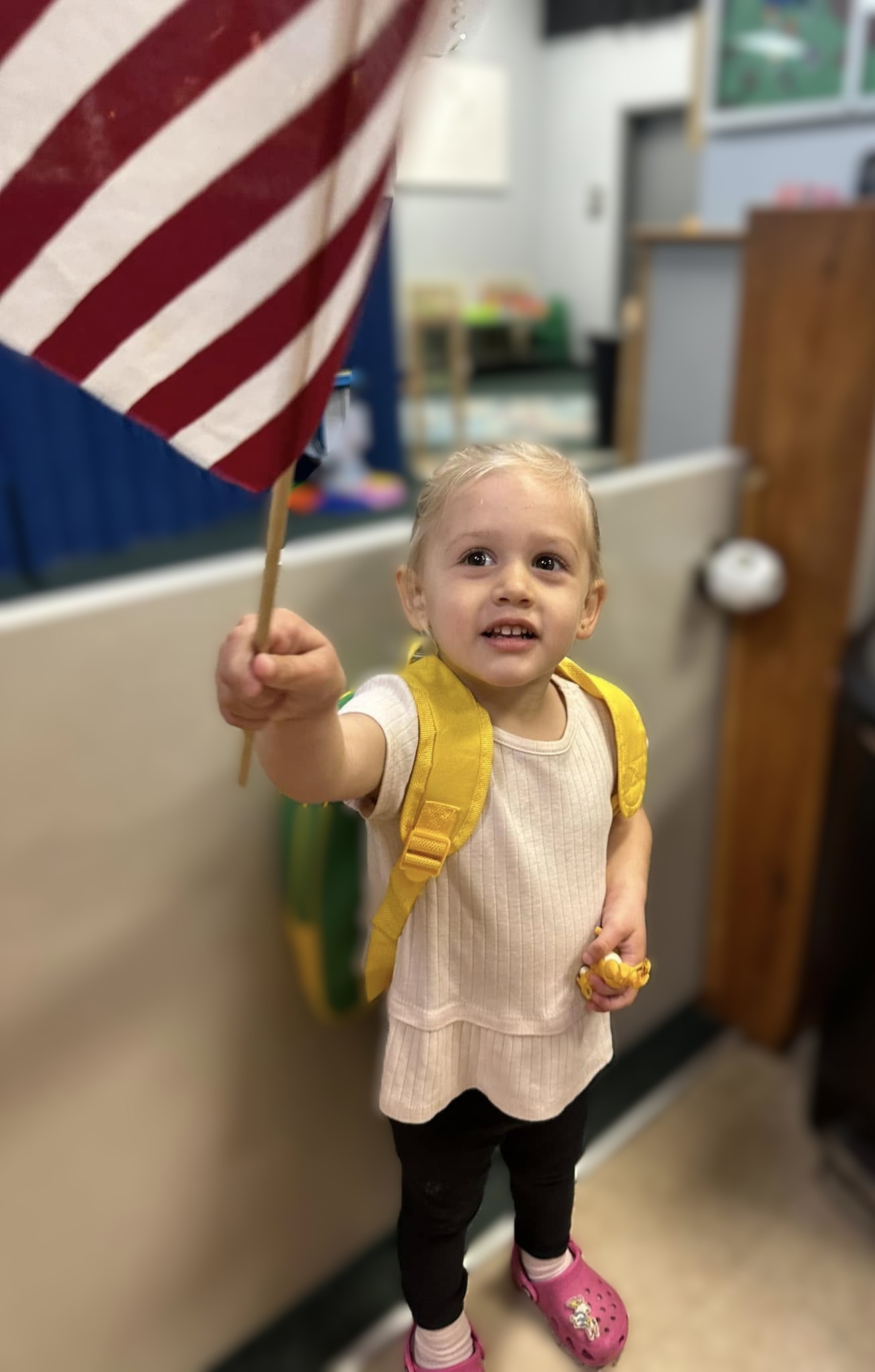Toddler holding American flag