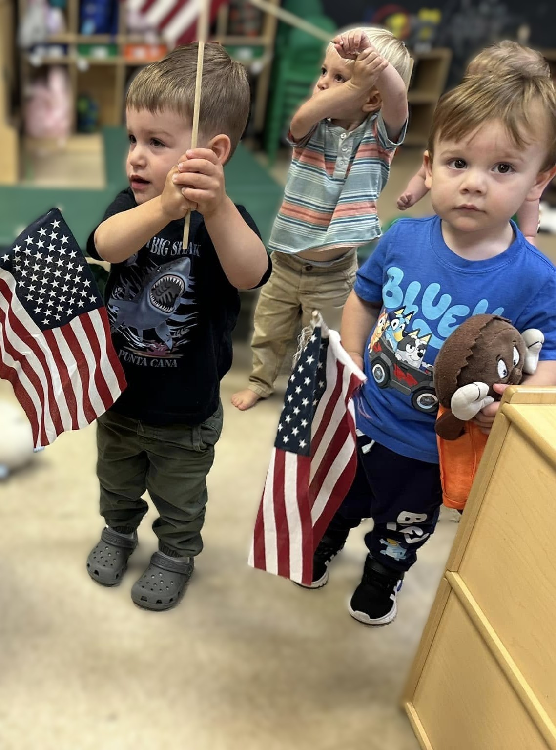 Toddlers holding American flags
