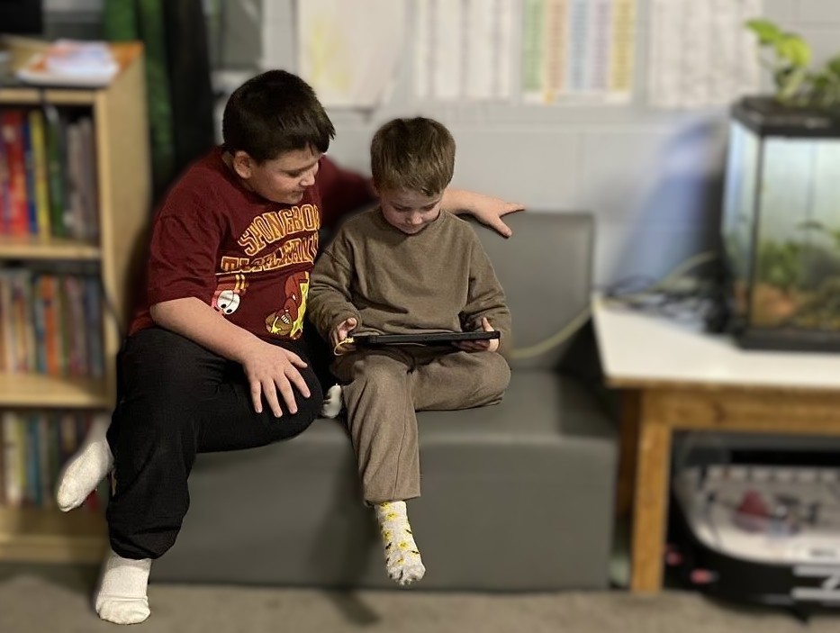 Two boys reading together