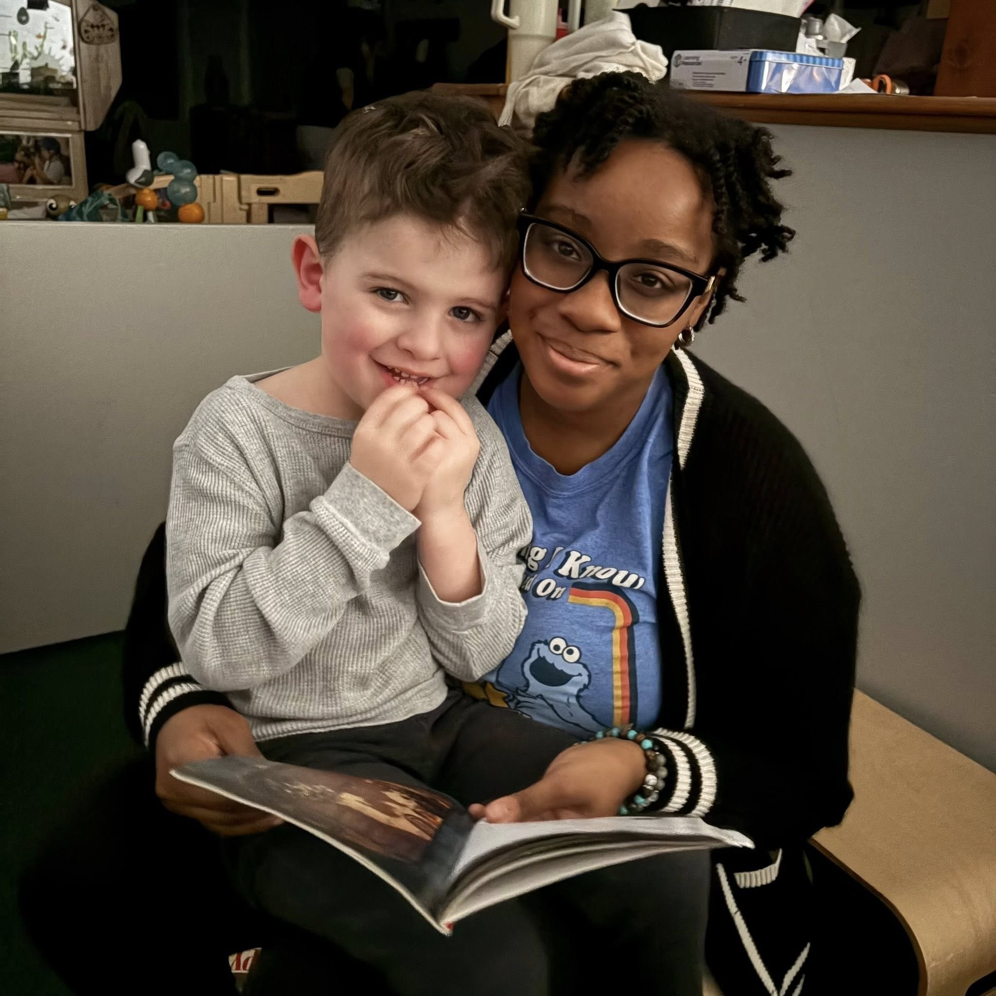 Teacher holding a baby in the classroom