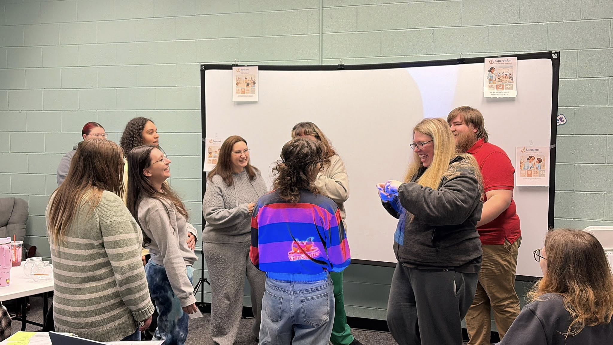 Teacher sitting on the floor with children