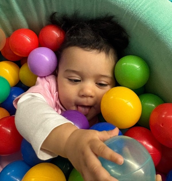 Toddler smiling in the ball pit