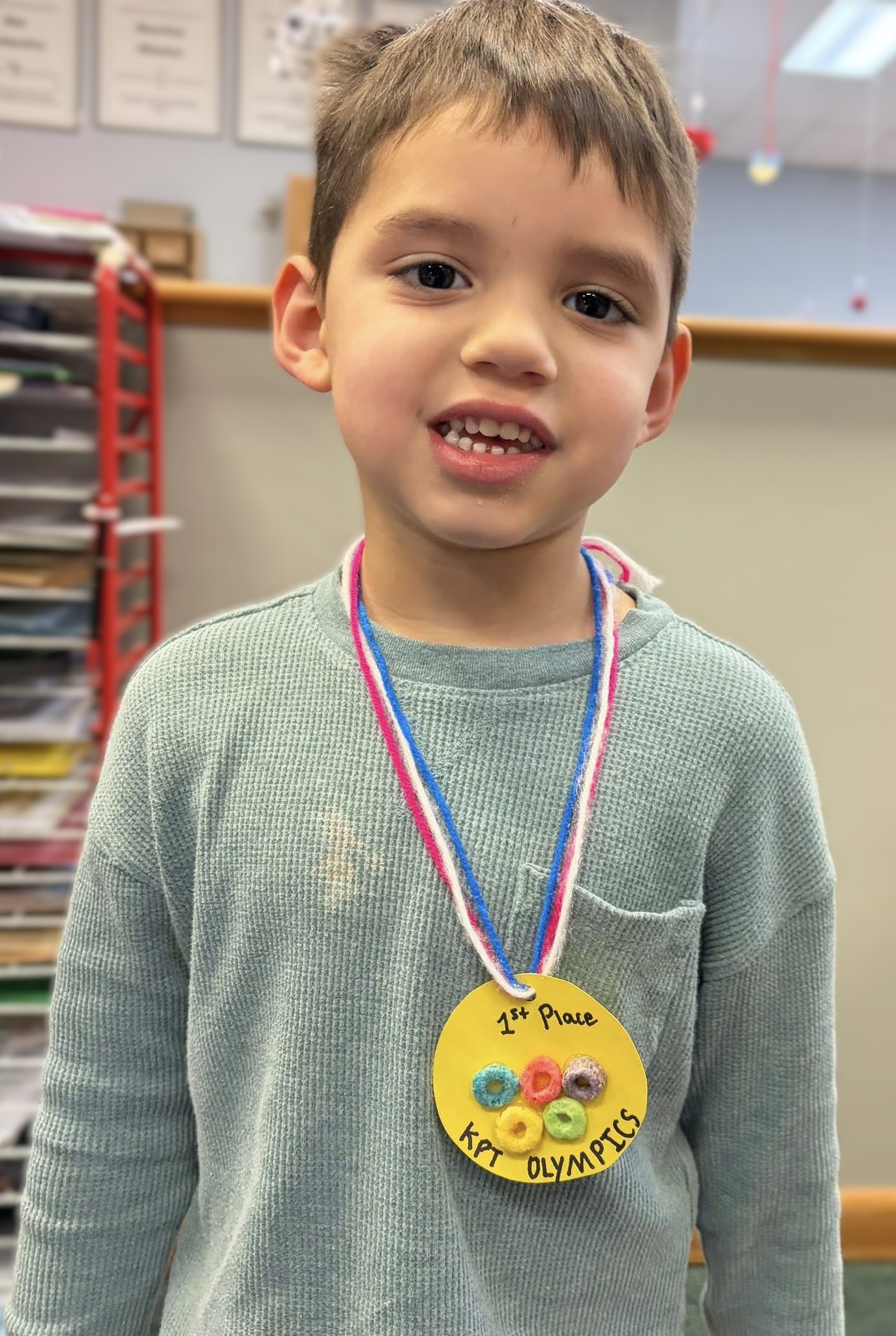 KPT student proudly wearing a first place KPT Olympics medal
