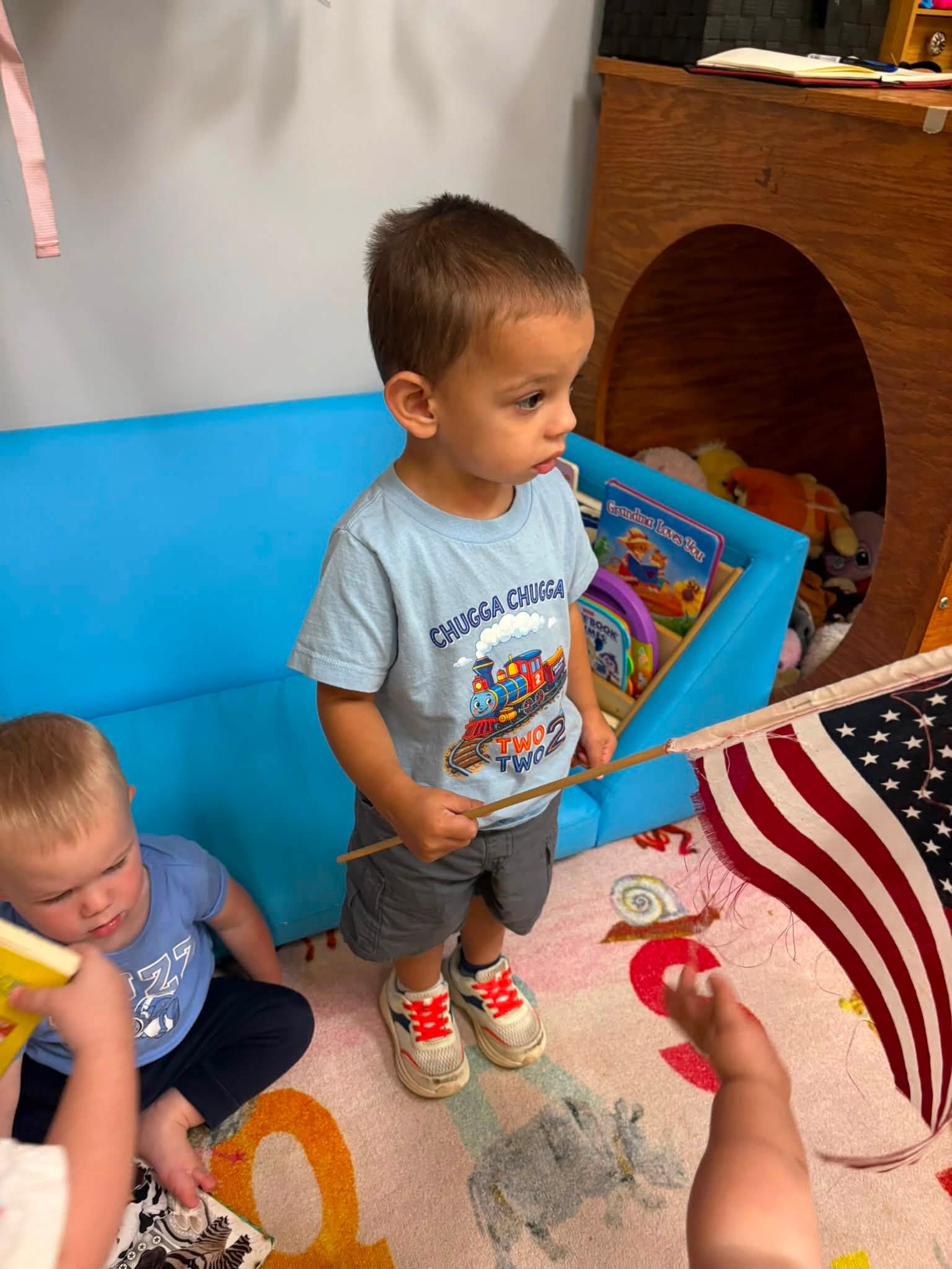 Toddler holding American Flag